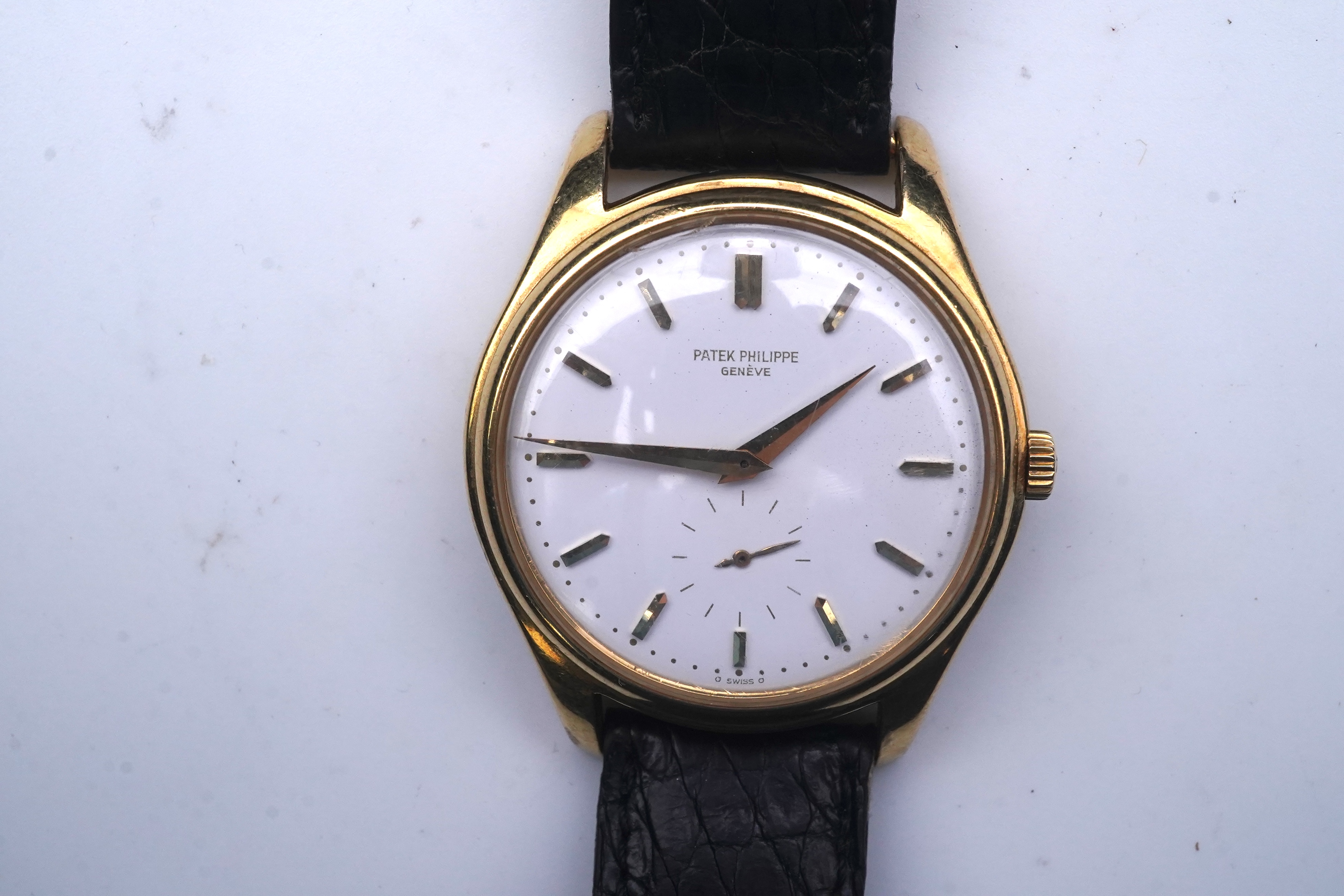 A gentleman's fine 18ct gold Patek Philippe Calatrava automatic wrist watch, model number 2526, on a Patek Philippe black leather strap with a Patek Philippe 18ct gold buckle